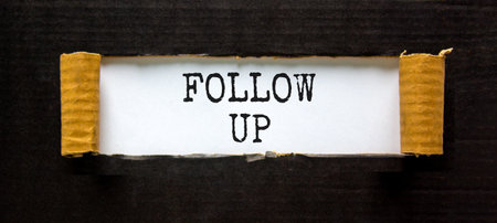 Follow up symbol. Concept word Follow up on beautiful white paper. Beautiful black paper background. Business follow up concept. Copy space.の写真素材