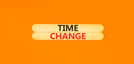Time change symbol. Concept word Time change on beautiful wooden sticks. Beautiful orange paper...