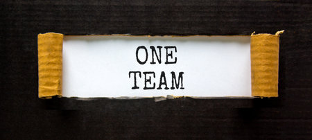 One team symbol. Concept word One team on beautiful white paper. Beautiful black paper background....