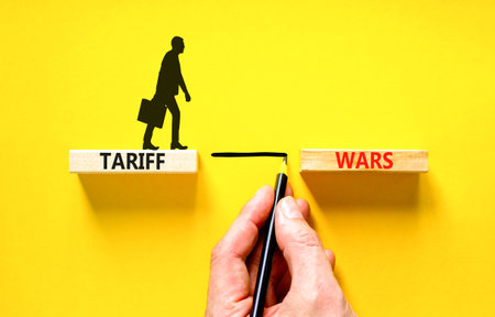 Trade tariff wars symbol. Concept word Tariff wars on beautiful wooden blocks. Beautiful yellow...