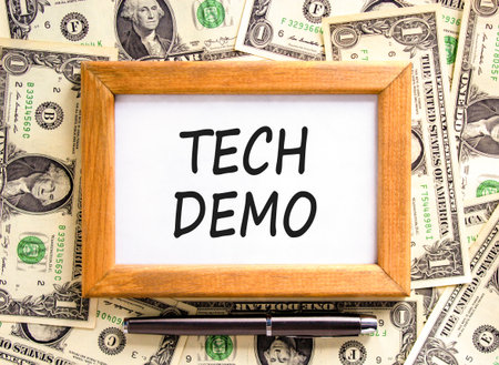 Tech demo symbol. Concept word Tech demo on beautiful wooden picture frame. Dollar bills. Beautiful...