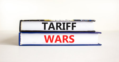Trade tariff wars symbol. Concept word Tariff wars on beautiful books. Beautiful white paper background. Business trade tariff wars concept. Copy space.の写真素材