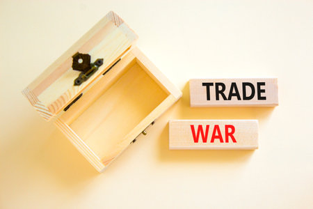 Trade war symbol. Concept word Trade war on beautiful wooden blocks. Beautiful white paper...