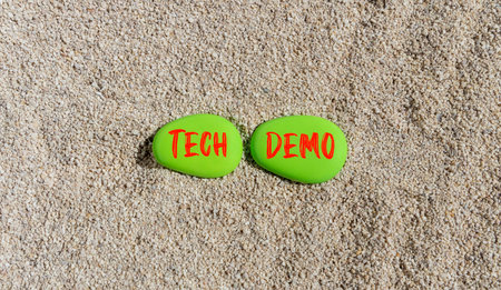 Tech demo symbol. Concept word Tech demo on beautiful green stones. Sea sand beach. Beautiful sand...
