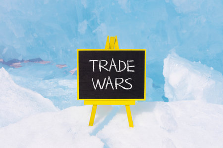 Trade wars symbol. Concept word Trade wars on beautiful black blackboard. Beautiful Baikal blue ice and snow background. Black blackboard. Business trade wars concept. Copy space.の写真素材