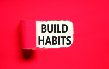 Build habits symbol. Concept word Build habits on beautiful white paper. Beautiful red paper...