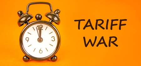 Trade tariff war symbol. Concept word Tariff war on beautiful orange paper. Beautiful black alarm...
