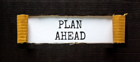 Plan ahead symbol. Concept word Plan ahead on beautiful white paper. Beautiful black paper background. Business plan ahead concept. Copy space.の写真素材