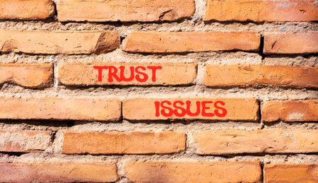 Trust issues symbol. Concept word Trust issues on beautiful old brown brick wall. Beautiful old...
