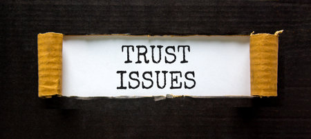 Trust issues symbol. Concept word Trust issues on beautiful white paper. Beautiful black paper...