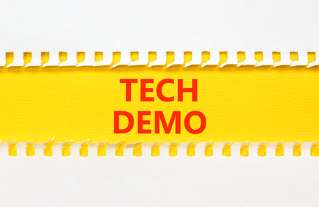 Tech demo symbol. Concept word Tech demo on beautiful white paper. Beautiful yellow paper background. Business tech demo concept. Copy space.の写真素材