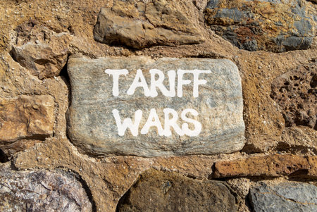 Trade tariff wars symbol. Concept word Tariff wars on beautiful gray stone on stone wall. Beautiful stone wall background. Business trade tariff wars concept. Copy space.の写真素材