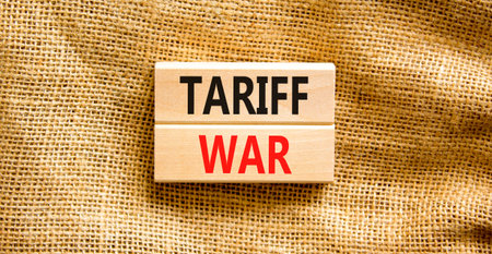 Trade tariff war symbol. Concept word Tariff war on beautiful wooden blocks. Beautiful canvas...