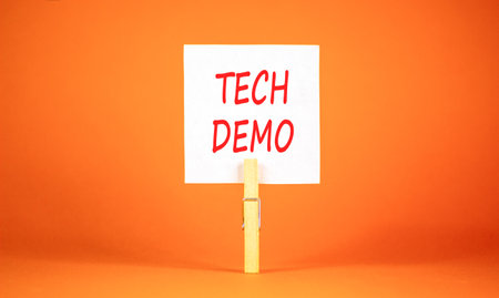 Tech demo symbol. Concept word Tech demo on beautiful white paper. Beautiful wooden clothespin....