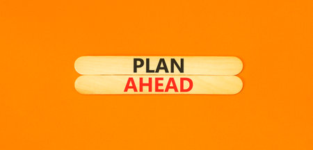 Plan ahead symbol. Concept word Plan ahead on beautiful wooden sticks. Beautiful orange paper...
