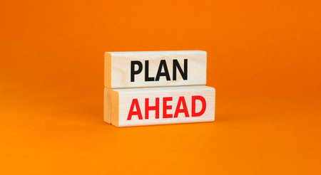 Plan ahead symbol. Concept word Plan ahead on beautiful wooden blocks. Beautiful orange paper...