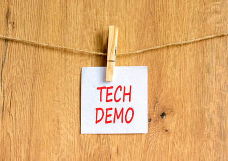 Tech demo symbol. Concept word Tech demo on beautiful white paper. Beautiful wooden clothespin....