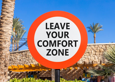 Leave your comfort zone symbol. Concept words Leave your comfort zone on beautiful road sign. Beautiful palm blue sky background. Business psychological Leave your comfort zone concept. Copy space.の写真素材