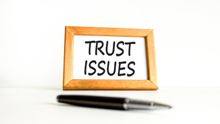 Trust issues symbol. Concept word Trust issues on beautiful wooden picture frame. Black pen....