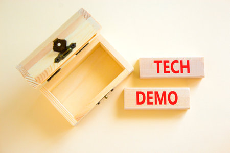 Tech demo symbol. Concept word Tech demo on beautiful wooden blocks. Beautiful white paper...