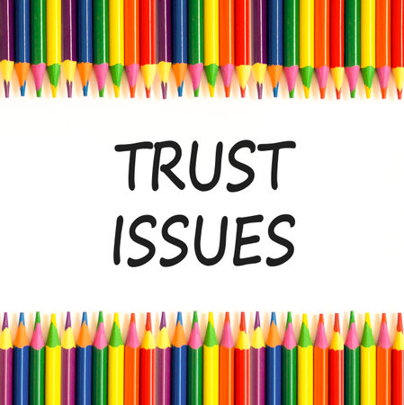 Trust issues symbol. Concept word Trust issues on beautiful white paper. Colored pencils. Beautiful...