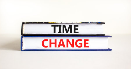 Time change symbol. Concept word Time change on beautiful books. Beautiful white paper background. Business time change concept. Copy space.の写真素材