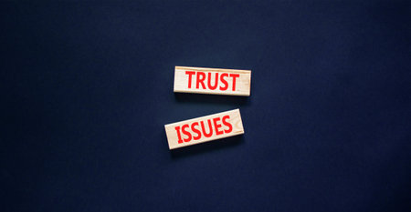 Trust issues symbol. Concept word Trust issues on beautiful wooden blocks. Beautiful black paper background. Business trust issues concept. Copy space.の写真素材