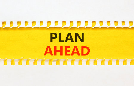 Plan ahead symbol. Concept word Plan ahead on beautiful white paper. Beautiful yellow paper background. Business plan ahead concept. Copy space.の写真素材