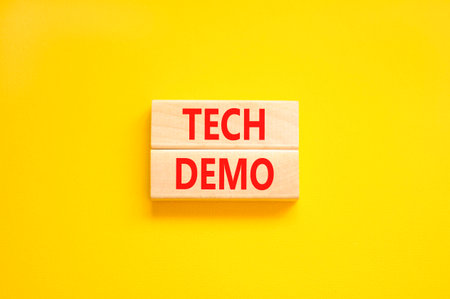 Tech demo symbol. Concept word Tech demo on beautiful wooden blocks. Beautiful yellow paper background. Business tech demo concept. Copy space.の写真素材