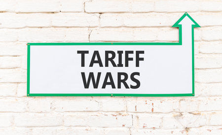 Trade tariff wars symbol. Concept word Tariff wars on beautiful white sign on white brick wall. Beautiful white brick wall background. Business trade tariff wars concept. Copy space.の写真素材