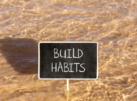 Build habits symbol. Concept word Build habits on beautiful black blackboard. Beautiful Red sea...