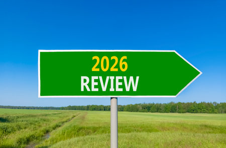 2026 Review symbol. Concept words 2026 Review on beautiful green road sign. Beautiful green grass...