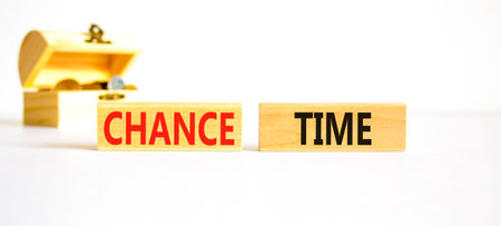 Chance time symbol. Concept word Chance time on beautiful wooden blocks. Beautiful white paper background. Beautiful wooden chest with coins. Business chance time concept. Copy space.の写真素材