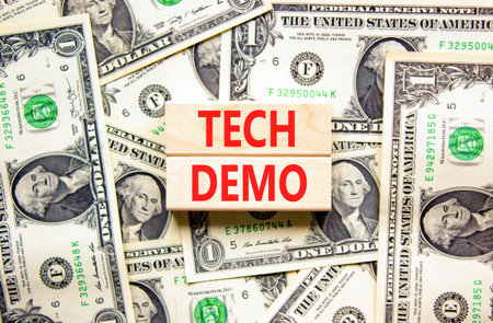 Tech demo symbol. Concept word Tech demo on beautiful wooden blocks. Dollar bills. Beautiful dollar...