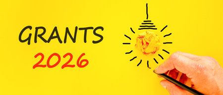 Grants 2026 symbol. Concept words Grants 2026 on beautiful yellow paper. Beautiful orange paper...