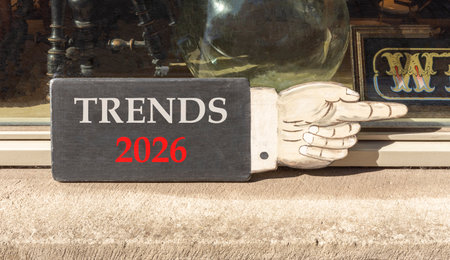 Trends 2026 new year symbol. Concept words Trends 2026 on beautiful black wooden hand sign. Beautiful shop display background. Business and Trends 2026 new year concept. Copy space.の写真素材