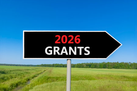 2026 Grants symbol. Concept words 2026 Grants on beautiful black road sign. Beautiful green grass...