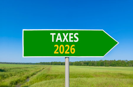Taxes 2026 new year symbol. Concept words Taxes 2026 on beautiful green road sign. Beautiful green...