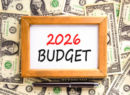 2026 Budget symbol. Concept words 2026 Budget on beautiful wooden picture frame. Beautiful dollar bills background. Black pen. Dollar bills. Business and 2026 budget concept. Copy space.の写真素材