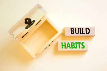 Build habits symbol. Concept word Build habits on beautiful wooden blocks. Beautiful white paper background. Empty wooden beautiful chest. Business build habits concept. Copy space.の写真素材