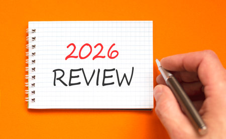 2026 Review symbol. Concept words 2026 Review on beautiful white note. Beautiful orange paper...
