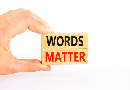 Words matter symbol. Concept word Words matter on beautiful wooden blocks. Beautiful white paper background. Businessman's hand. Business words matter concept. Copy space.の写真素材