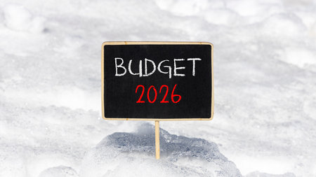 Budget 2026 symbol. Concept words Budget 2026 on beautiful black blackboard. Beautiful white snow...