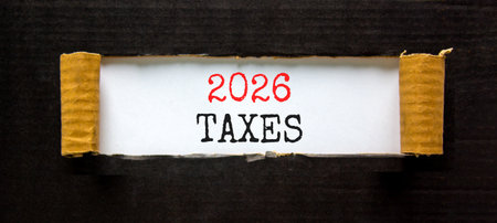 2026 taxes new year symbol. Concept words 2026 taxes on beautiful white paper. Beautiful black paper...