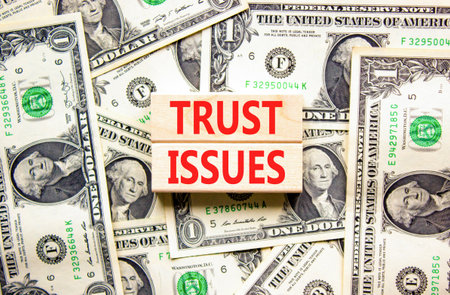 Trust issues symbol. Concept word Trust issues on beautiful wooden blocks. Dollar bills. Beautiful...