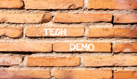 Tech demo symbol. Concept word Tech demo on beautiful old brown brick wall. Beautiful old brown brick wall background. Old brick wall. Business tech demo concept. Copy space.の写真素材
