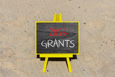 2026 Grants symbol. Concept words 2026 Grants on beautiful black blackboard. Beautiful sand beach background. Business and 2026 grants concept. Copy space.の写真素材
