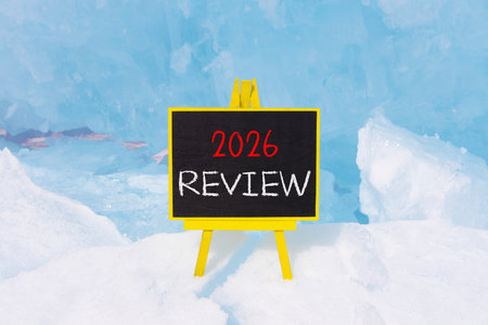 2026 Review symbol. Concept words 2026 Review on beautiful black blackboard. Beautiful blue lake...