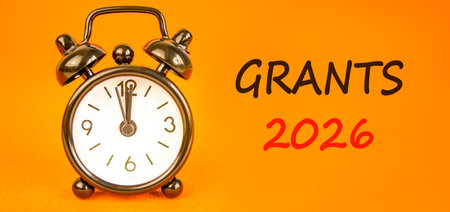 Grants 2026 symbol. Concept words Grants 2026 on beautiful orange paper. Beautiful orange paper...