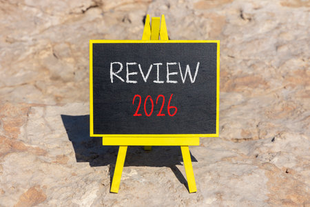 Review 2026 symbol. Concept words Review 2026 on beautiful black blackboard. Beautiful stone background. Business and review 2026 concept. Copy space.の写真素材